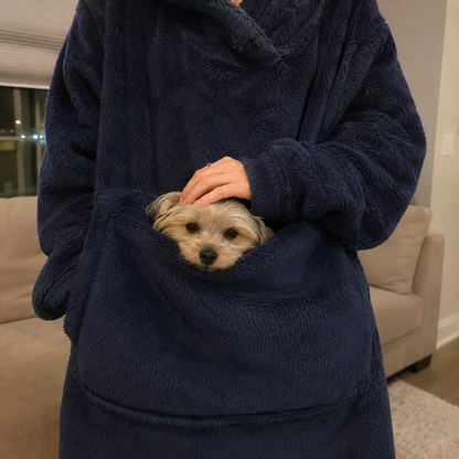 Close-up of a dog peeking out of the Joey hoodie's front pouch