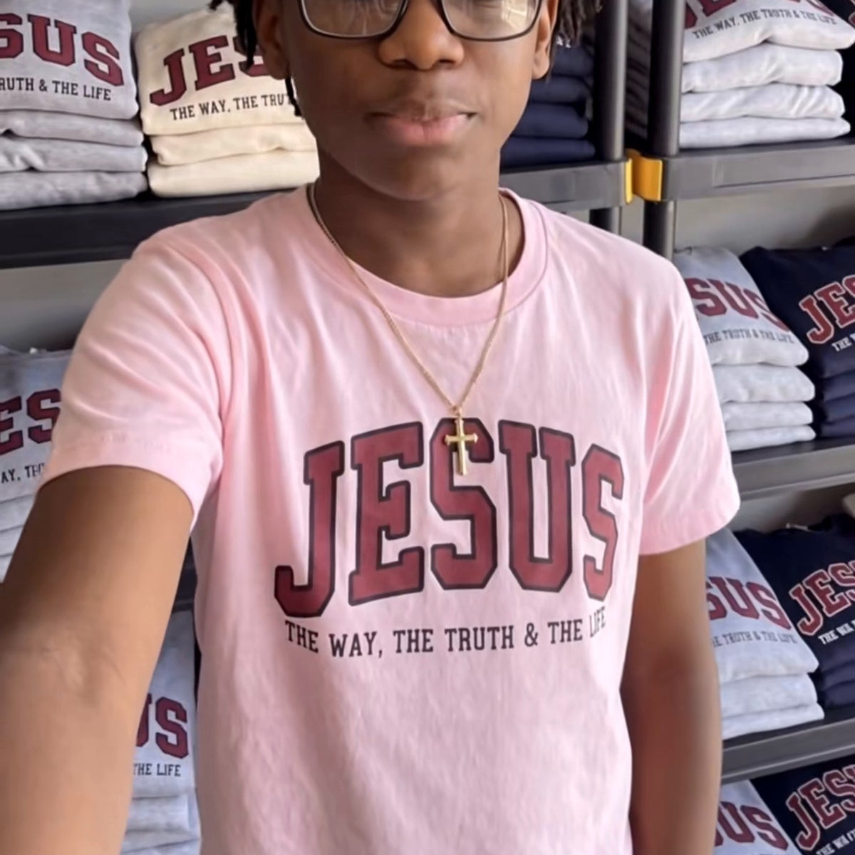 Actual pink JESUS varsity T-shirt being worn